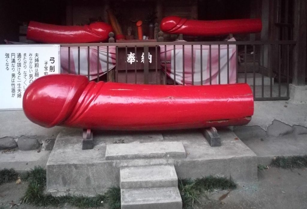 3 large red wooden phallus at shrine