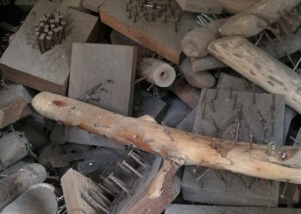 jumble of pieces of wood with nails