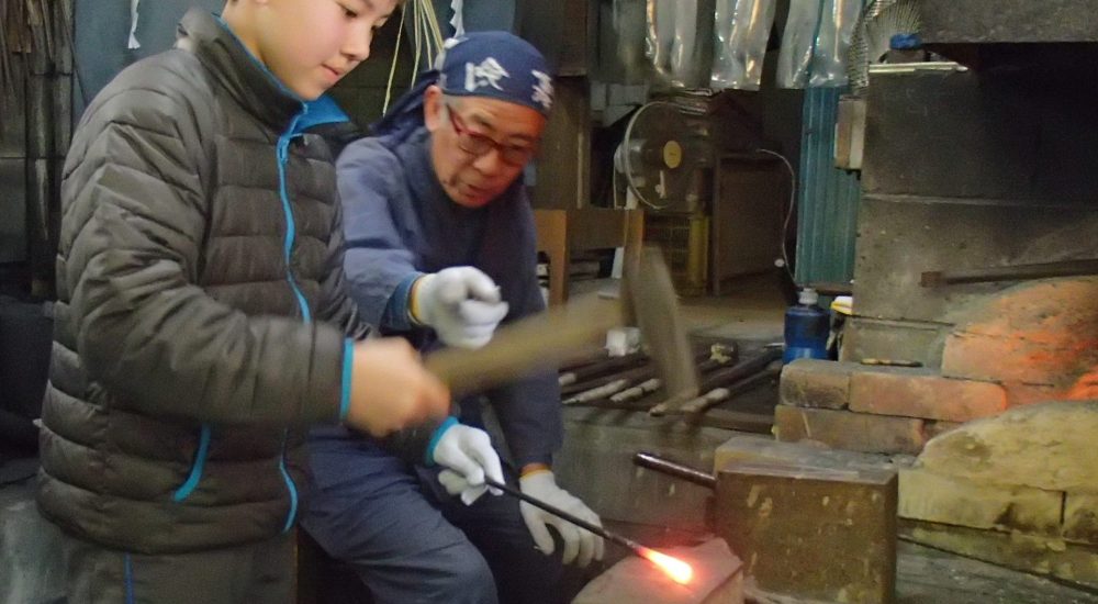 hammering steel in swordsmith's forgeExplore Kumamoto Samurai Swords tour